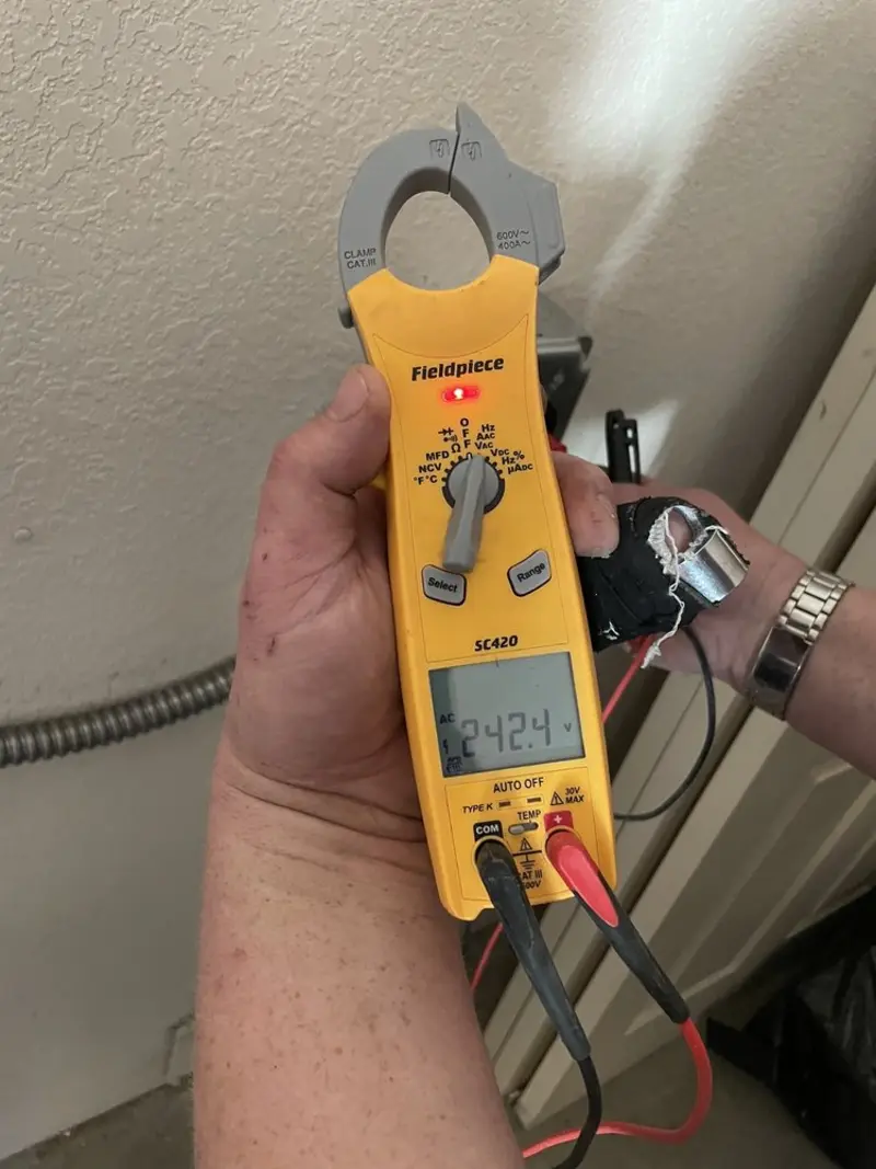 Voltage testing with clamp meter during Outlet Installation in Middle Valley